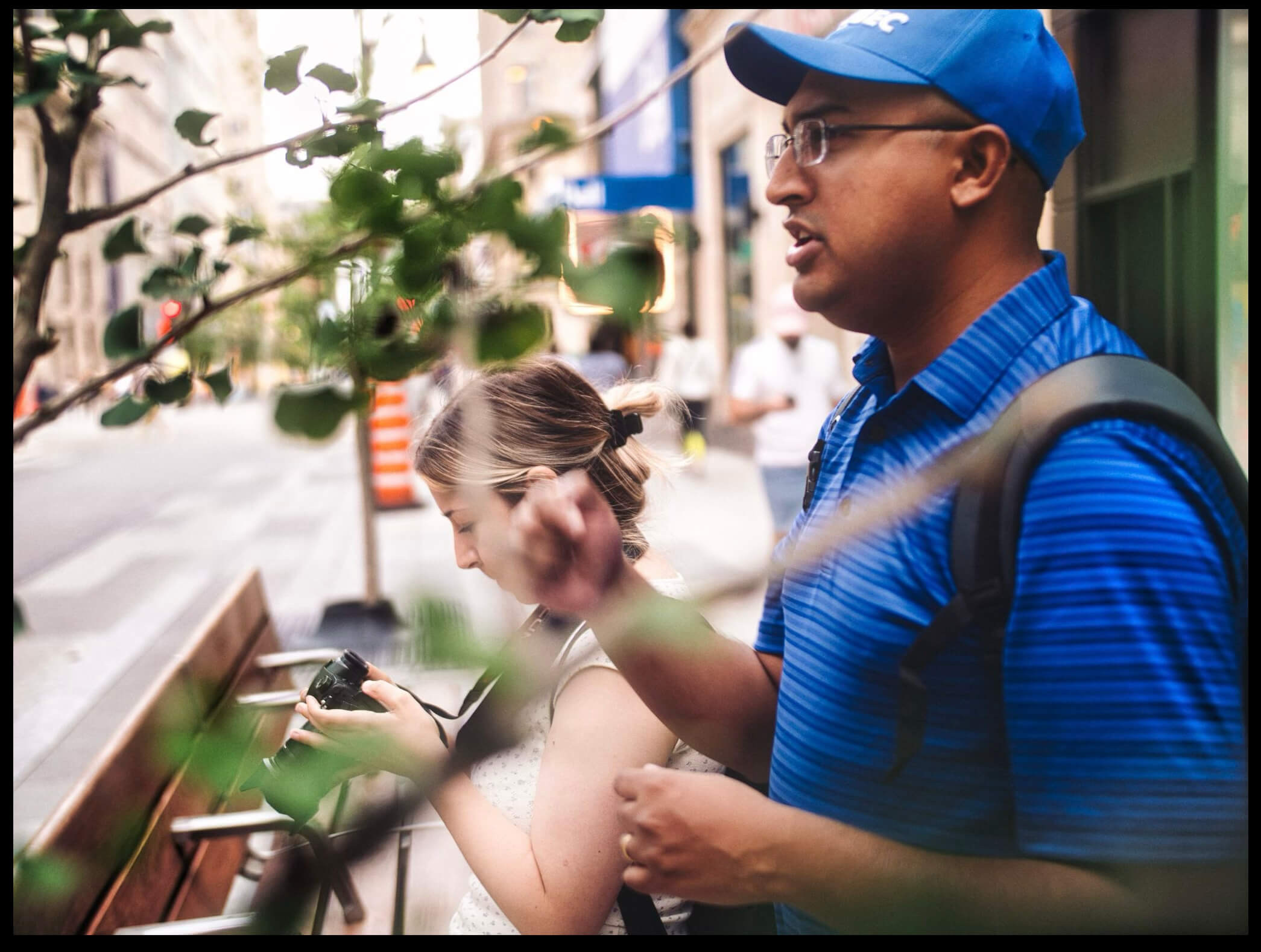 AJ Cordeiro walking through an urban setting with a camera, Toronto.